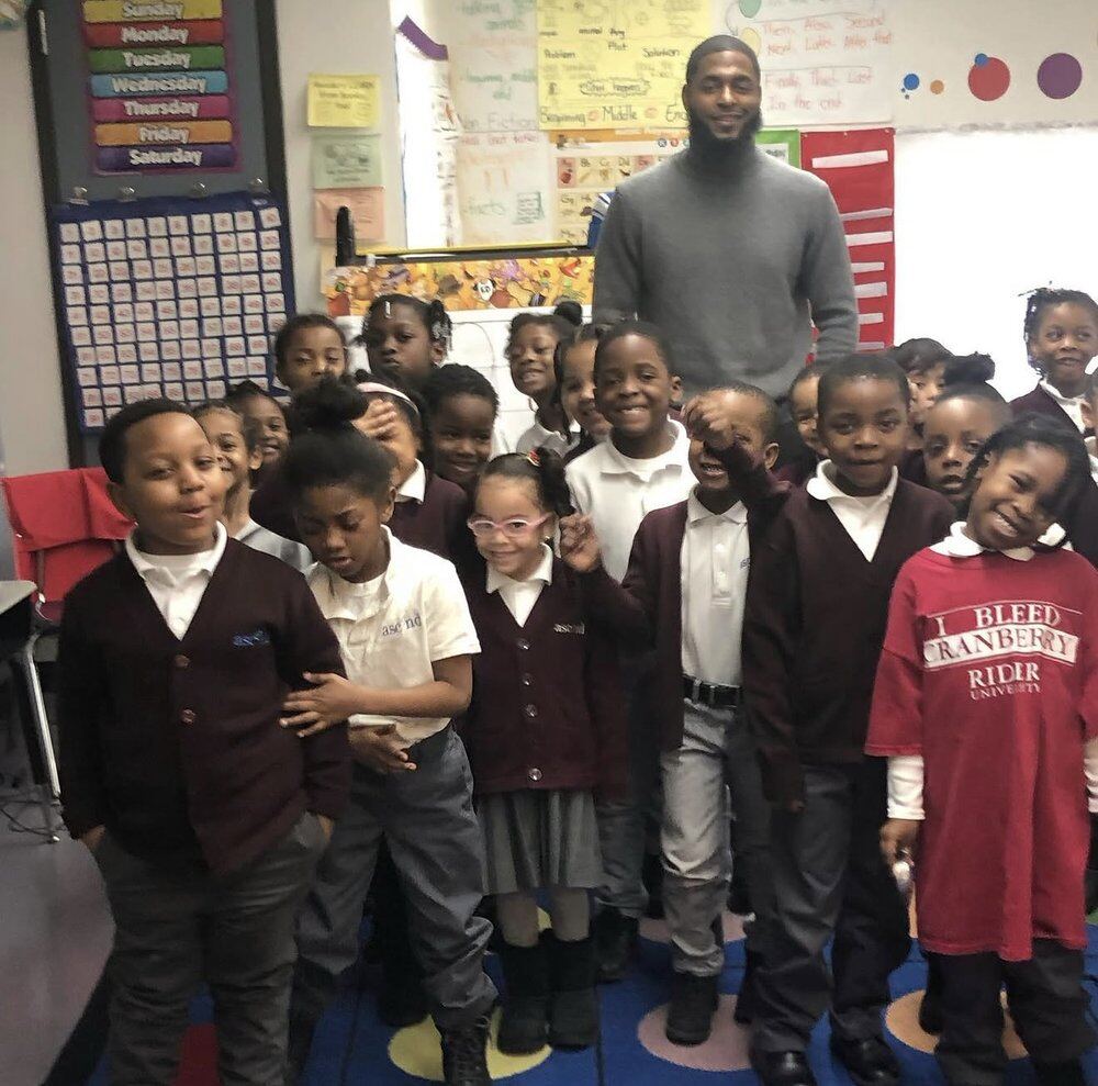 Brian Mays with students in Brooklyn's Lois Pink Houses